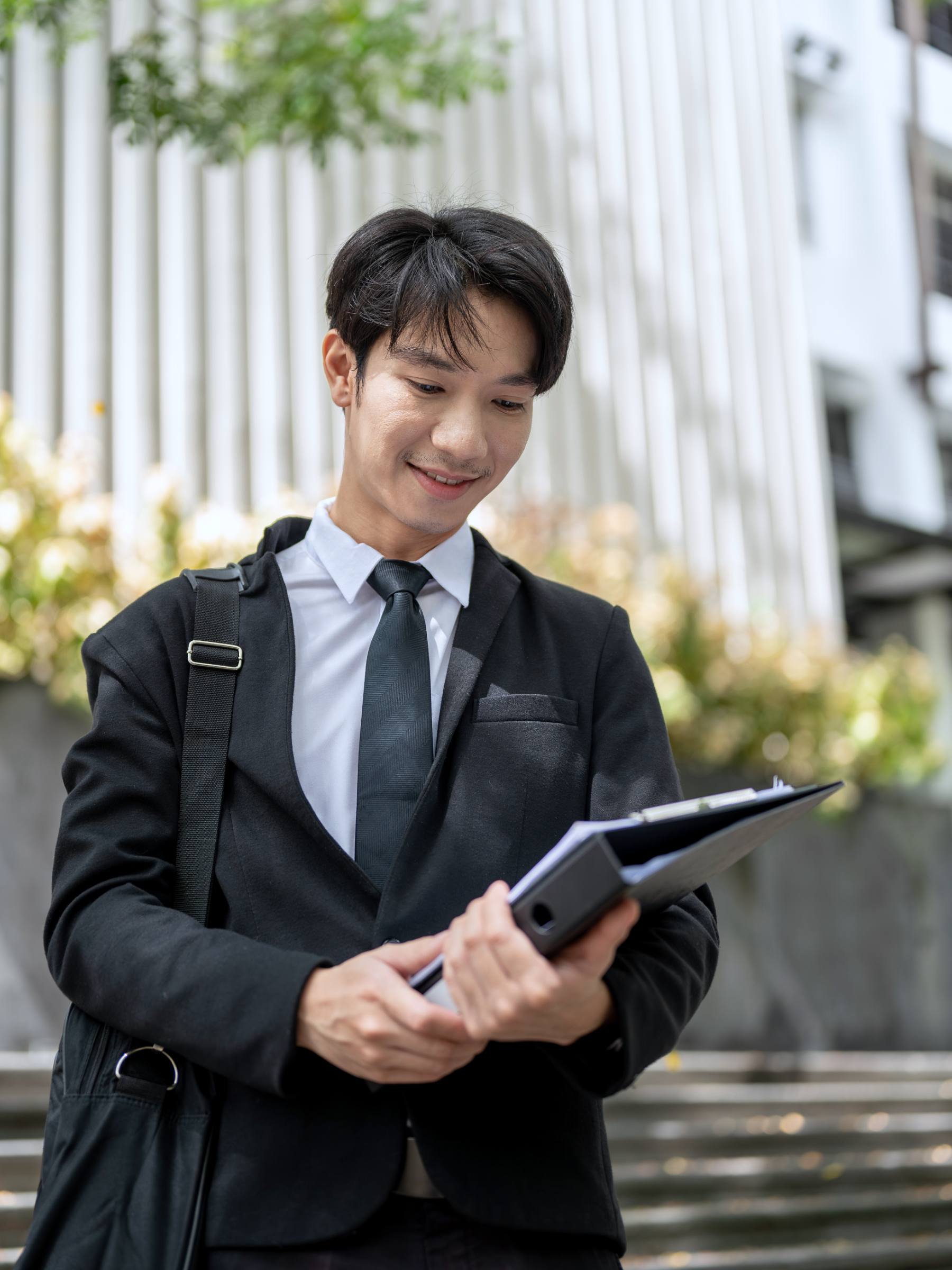 businessman-lawyer-with-his-bag-binder-is-walking-down-stairs-off-office