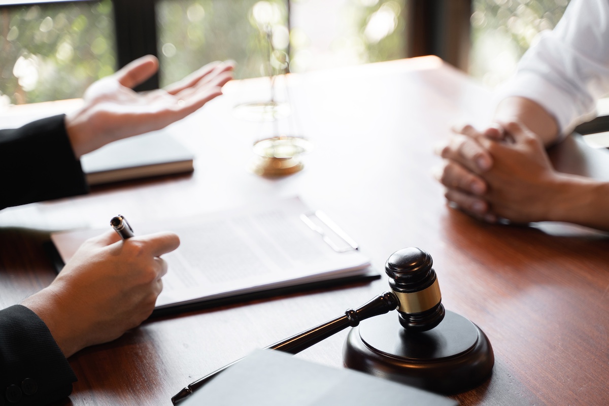 lawyer consulting with client discussing about lawsuit.